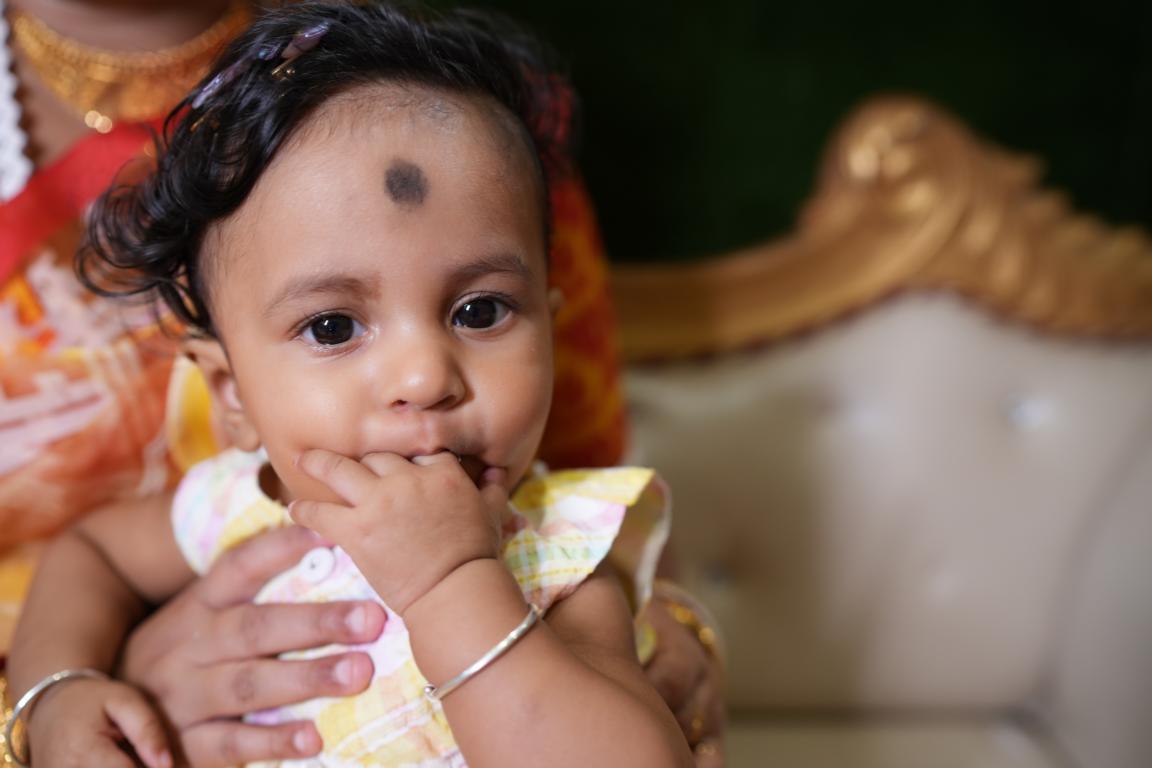 Happy family moments from baby’s annaprasan ceremony in Kolkata by Santanuz Gallery.