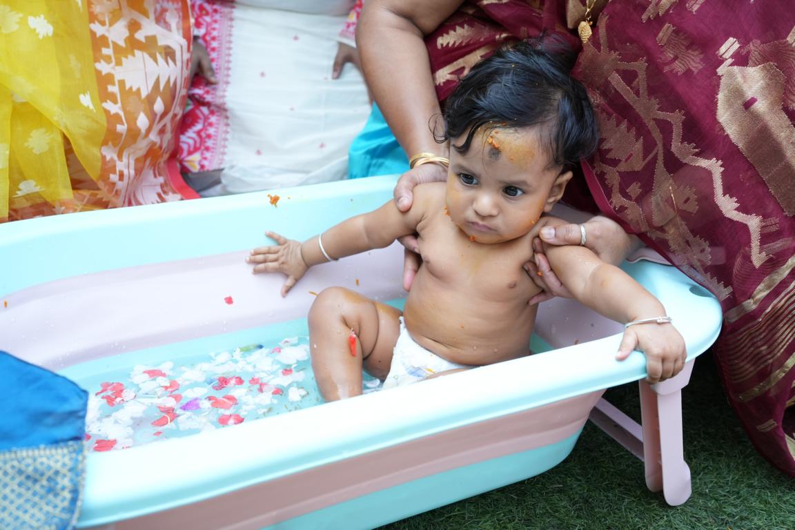 Happy family moments from baby’s annaprasan ceremony in Kolkata by Santanuz Gallery.