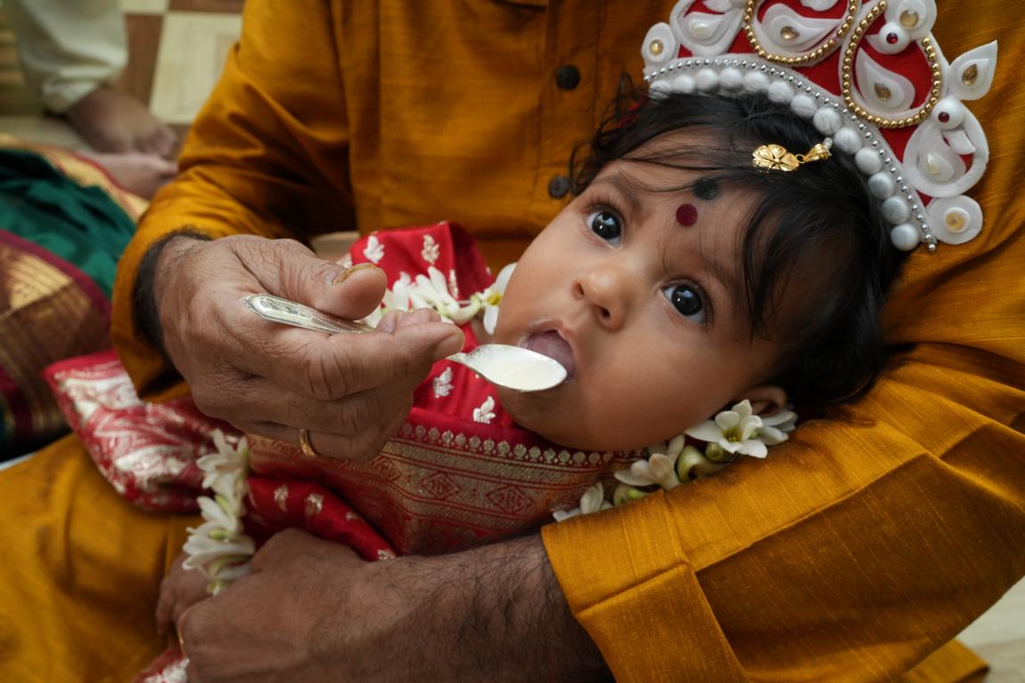Baby annaprasan photo in traditional attire captured in Kolkata by Santanuz Gallery.