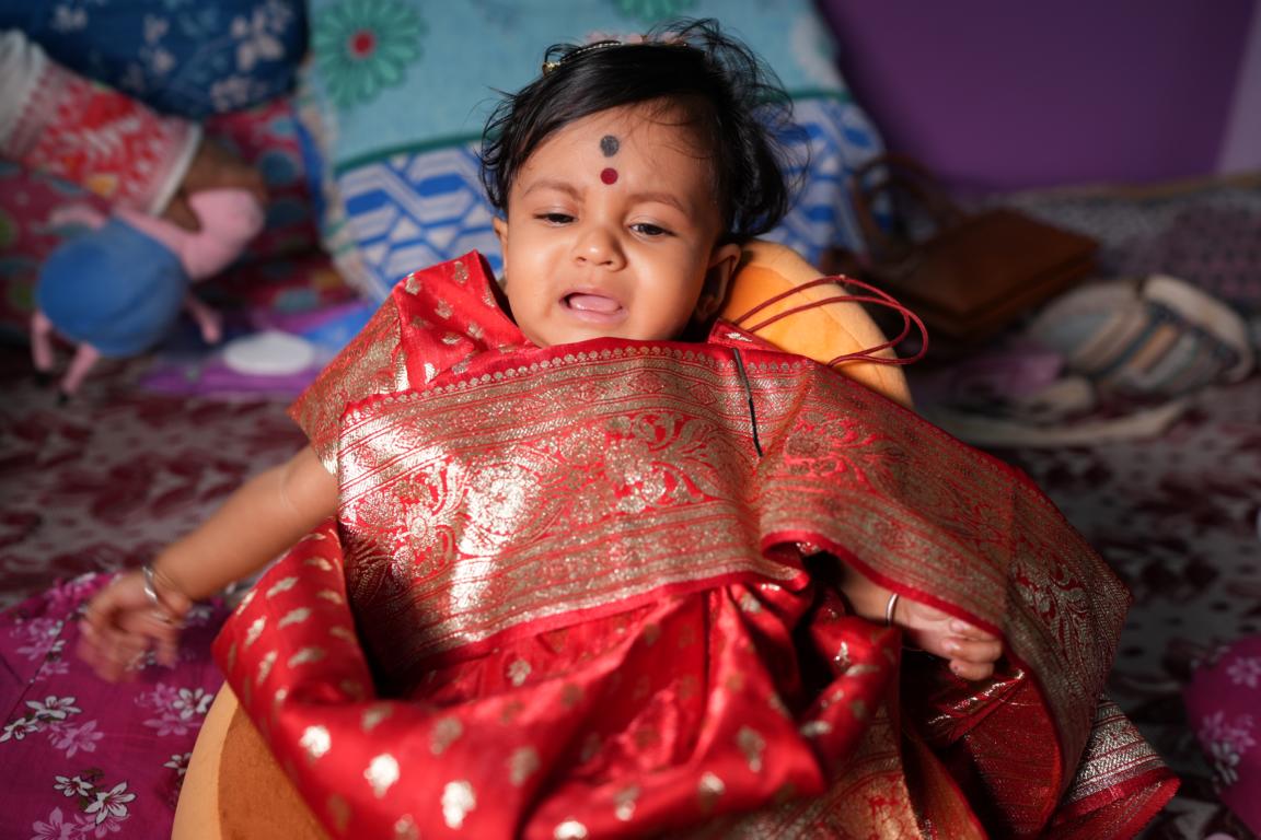 Baby annaprasan photo with parents in Kolkata by Santanuz Gallery.