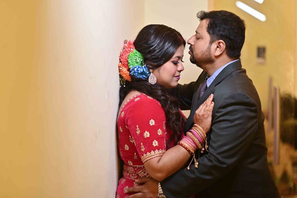 Close up candid of groom applying sindoor to bride