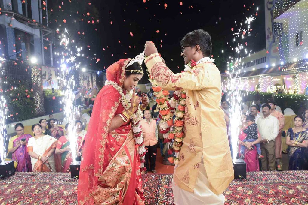 Formal traditional portrait of couple on wedding stage